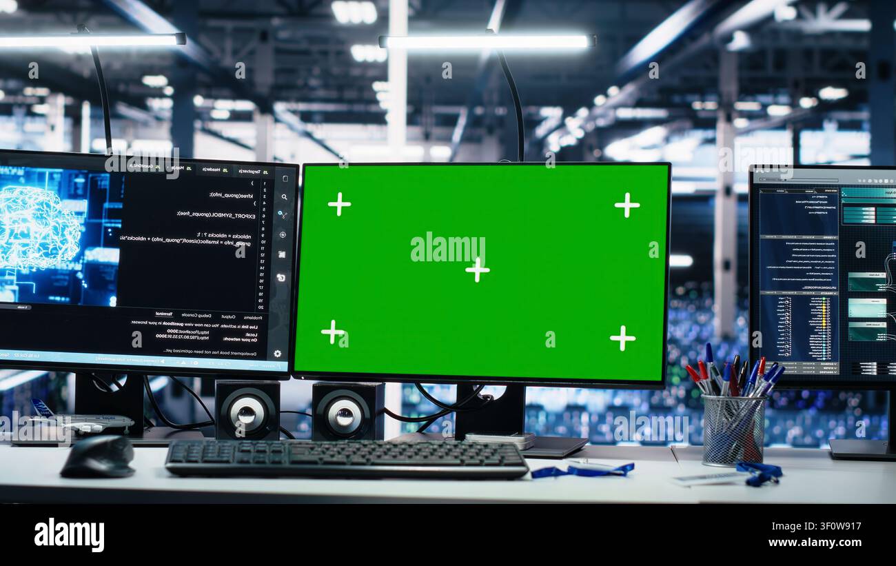 IT specialist reviews neural network visualization on green screen computers in a server room during software debugging work. Stock Photo