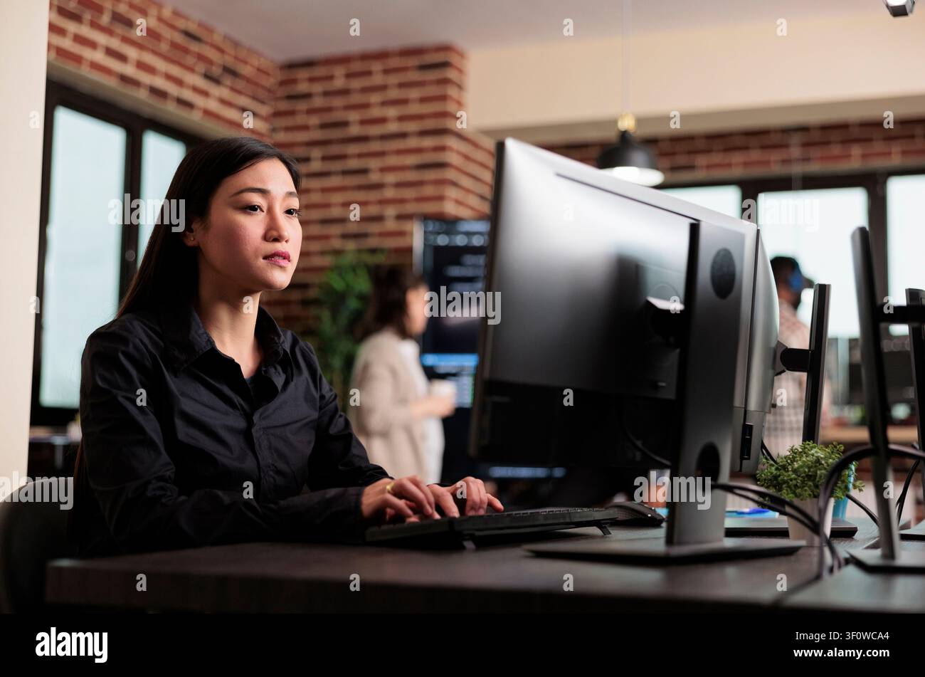Asian developer programs security algorithm with code with code, databases and network security work focused on data protection, firewalls and software development Stock Photo