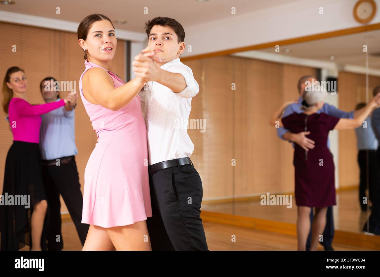 Young pair practicing ballroom dance in dance studio Stock Photo