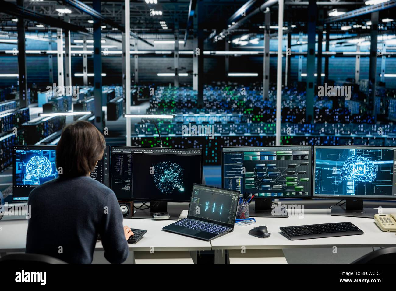 IT specialist working with computer in high tech computing hub with equipment supporting deep learning scientific simulations with computer scientist in server facility doing checkup on rackmounts. Stock Photo