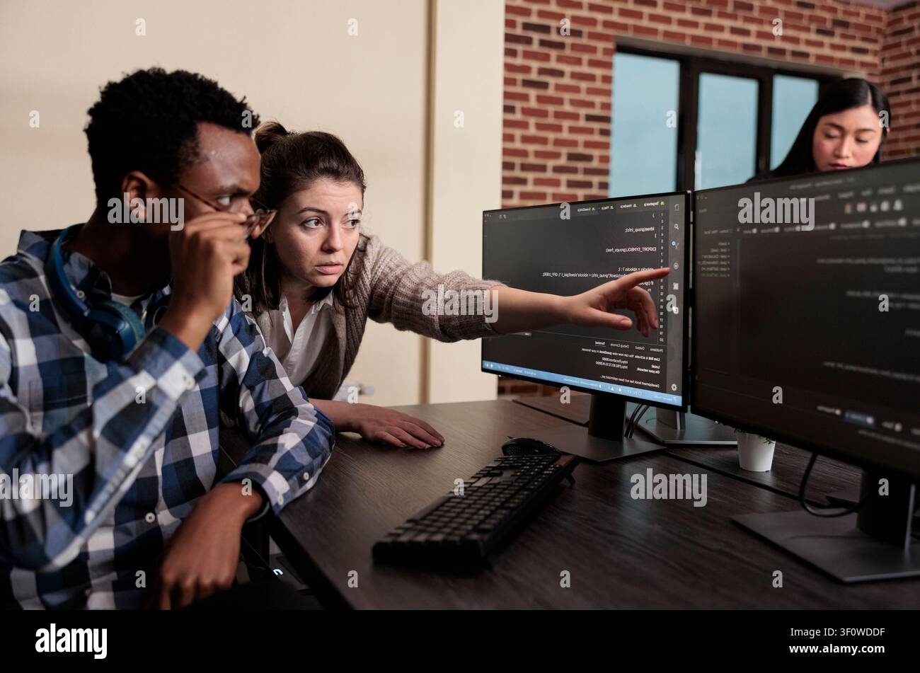 Software developer warning about security data breach Tech engineer observing multiple system security breaches caused by overloaded storage servers. Stock Photo