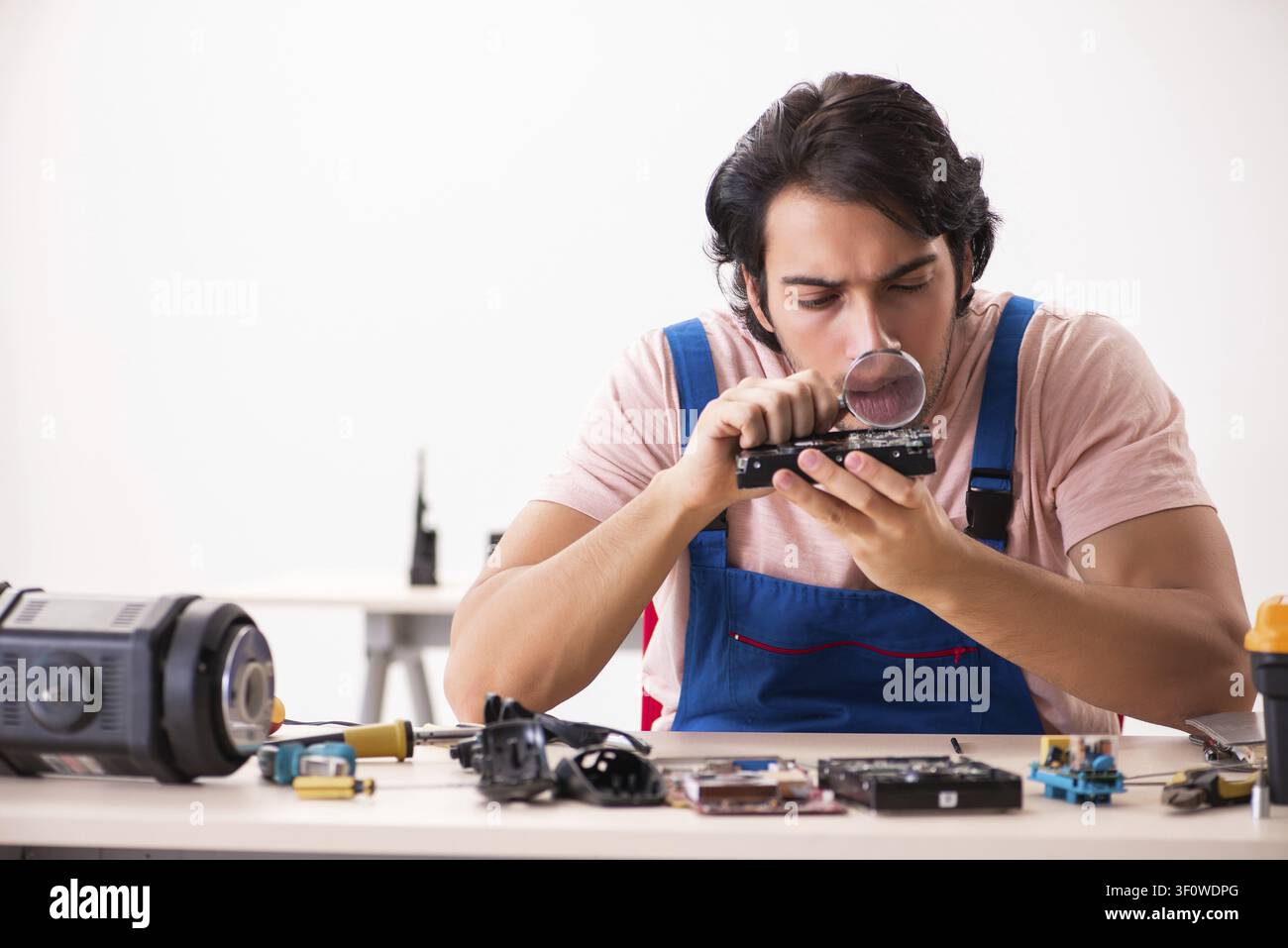 Young male contractor repairing computer Stock Photo
