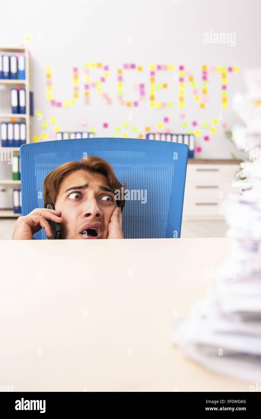 Young employee suffering from excessive work Stock Photo