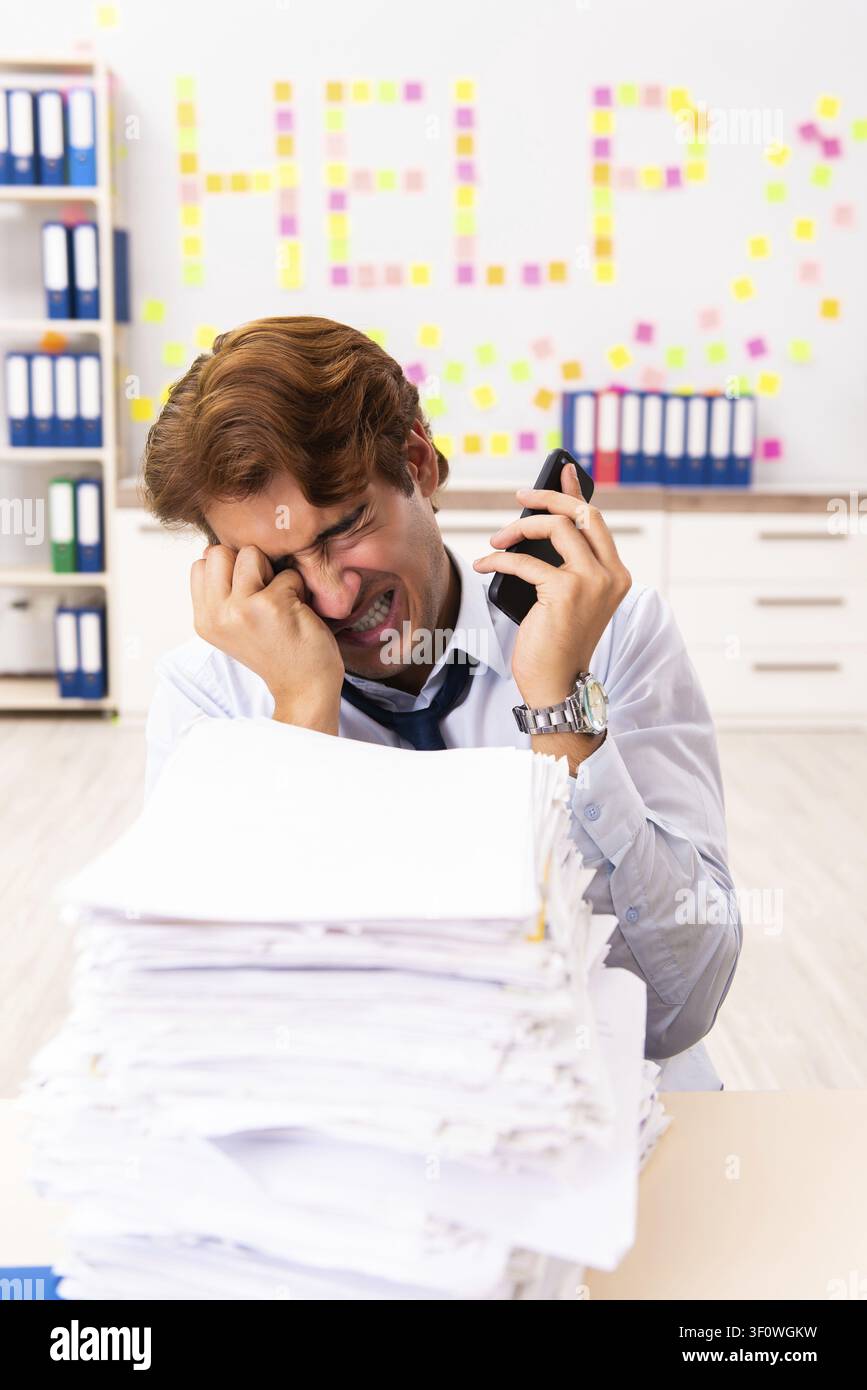 Young employee suffering from excessive work Stock Photo