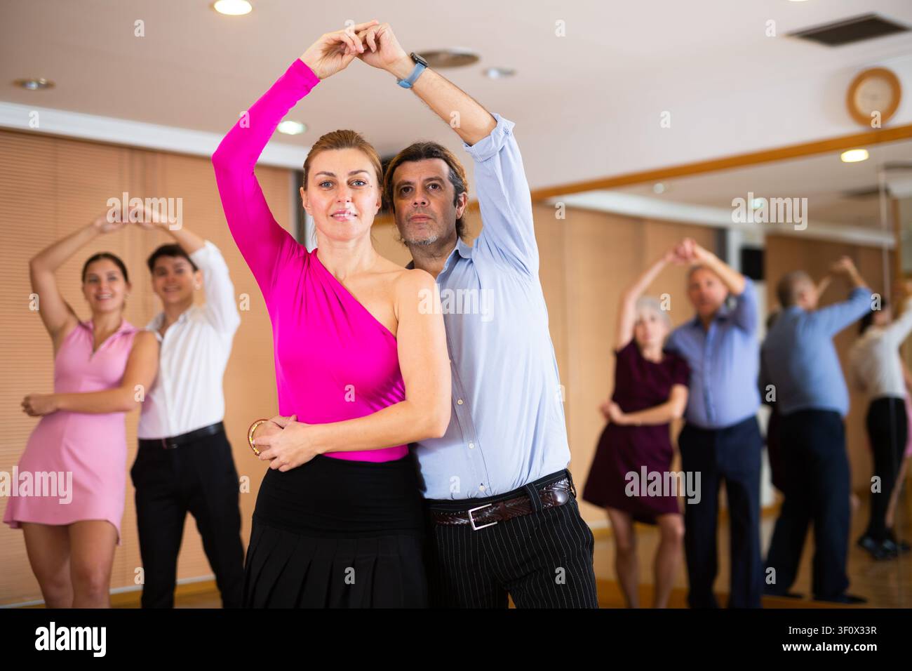 Woman and man practicing bachata in dance class Stock Photo