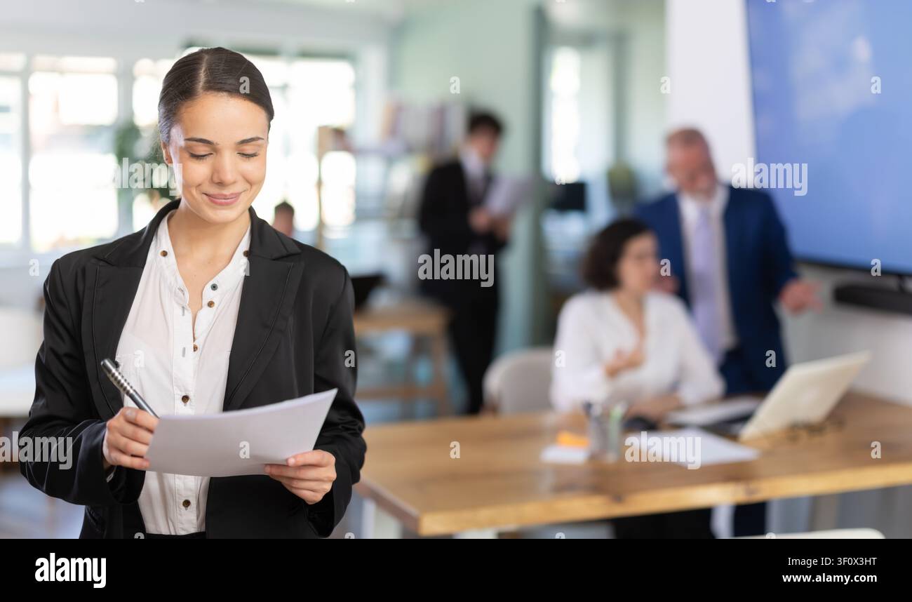 Young woman taking notes in document Stock Photo