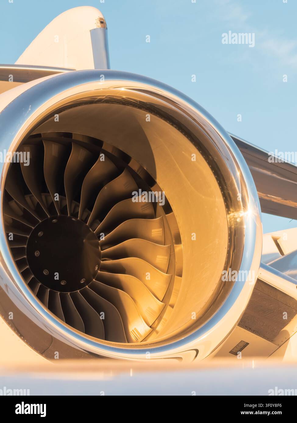 Private jet engine glowing in golden hour light Stock Photo