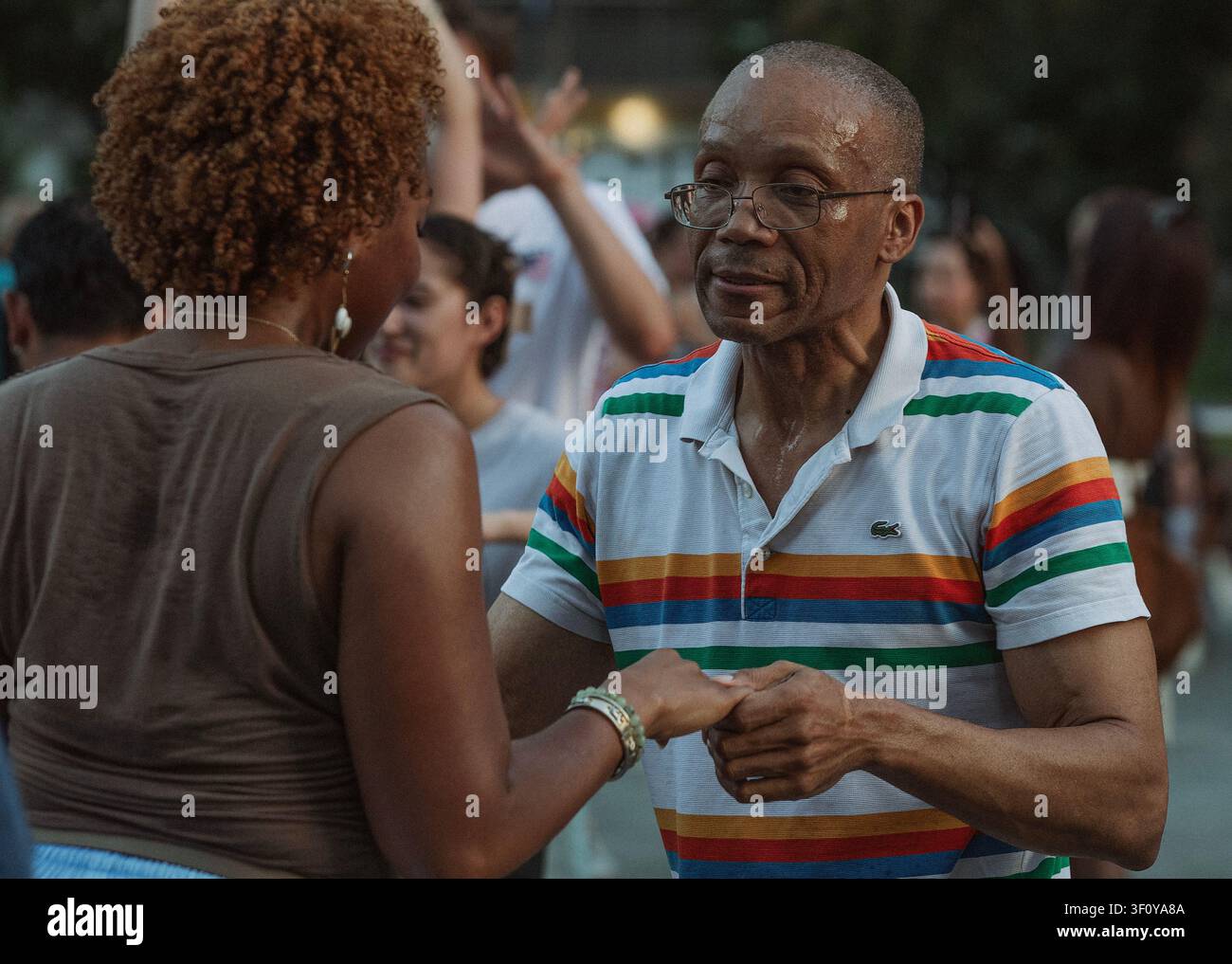 Happy older man dancing with woman outdoors Stock Photo