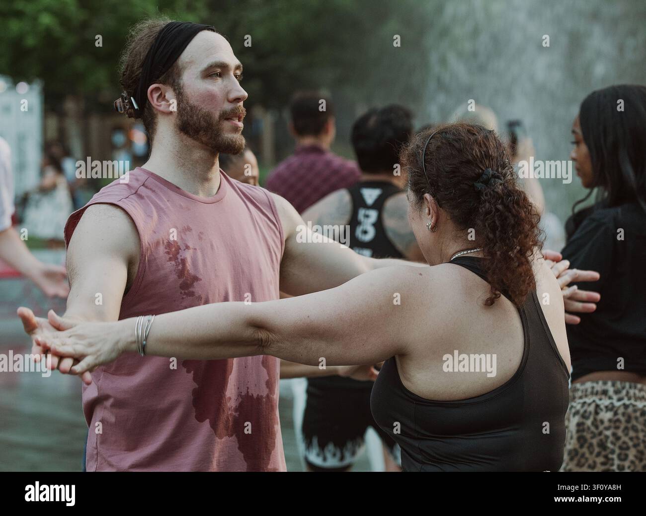 People dancing together in an outdoor class Stock Photo