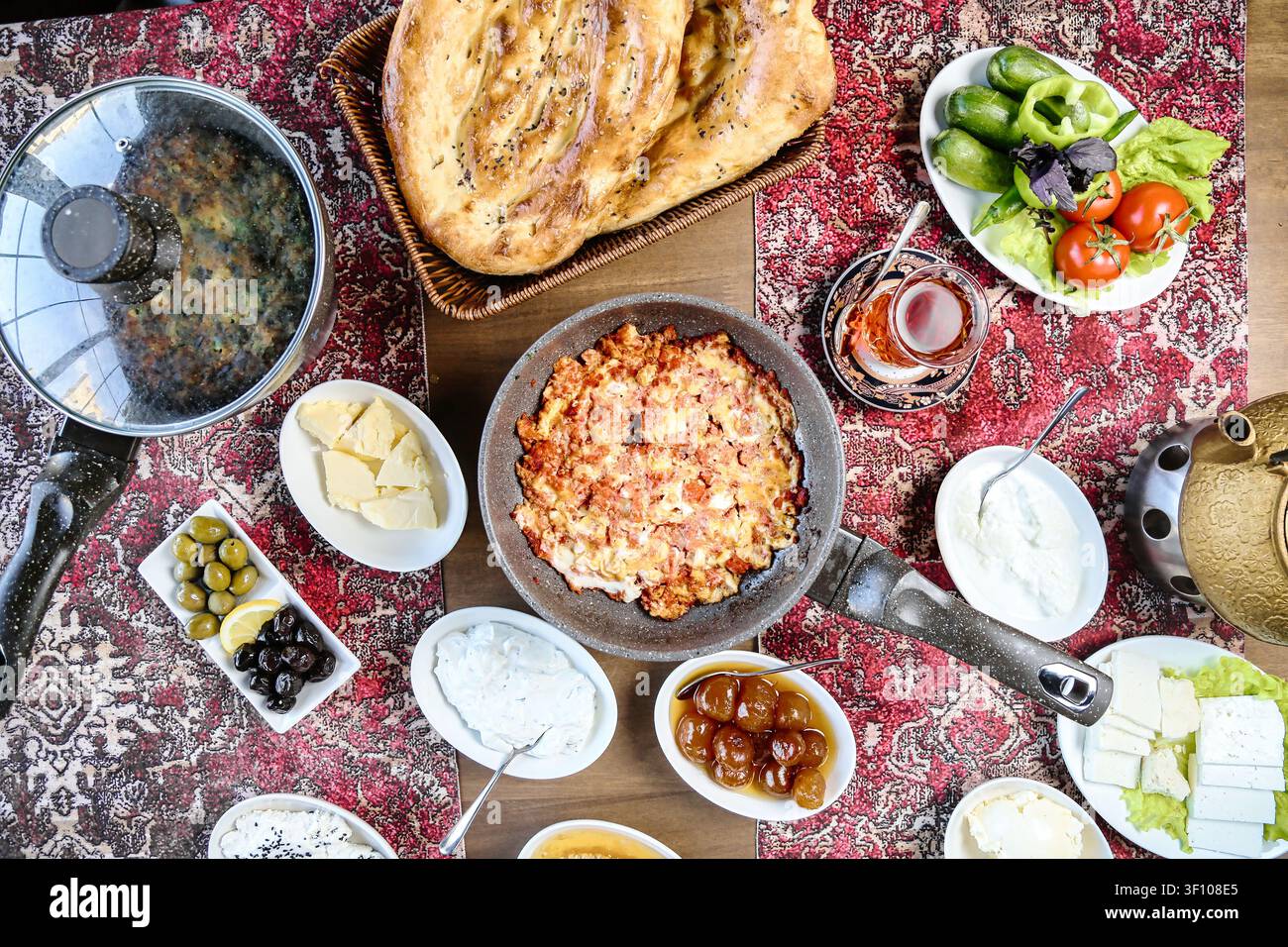 A table covered with a wide array of delicious and refreshing food and drinks, set for a lively gathering of people. Stock Photo