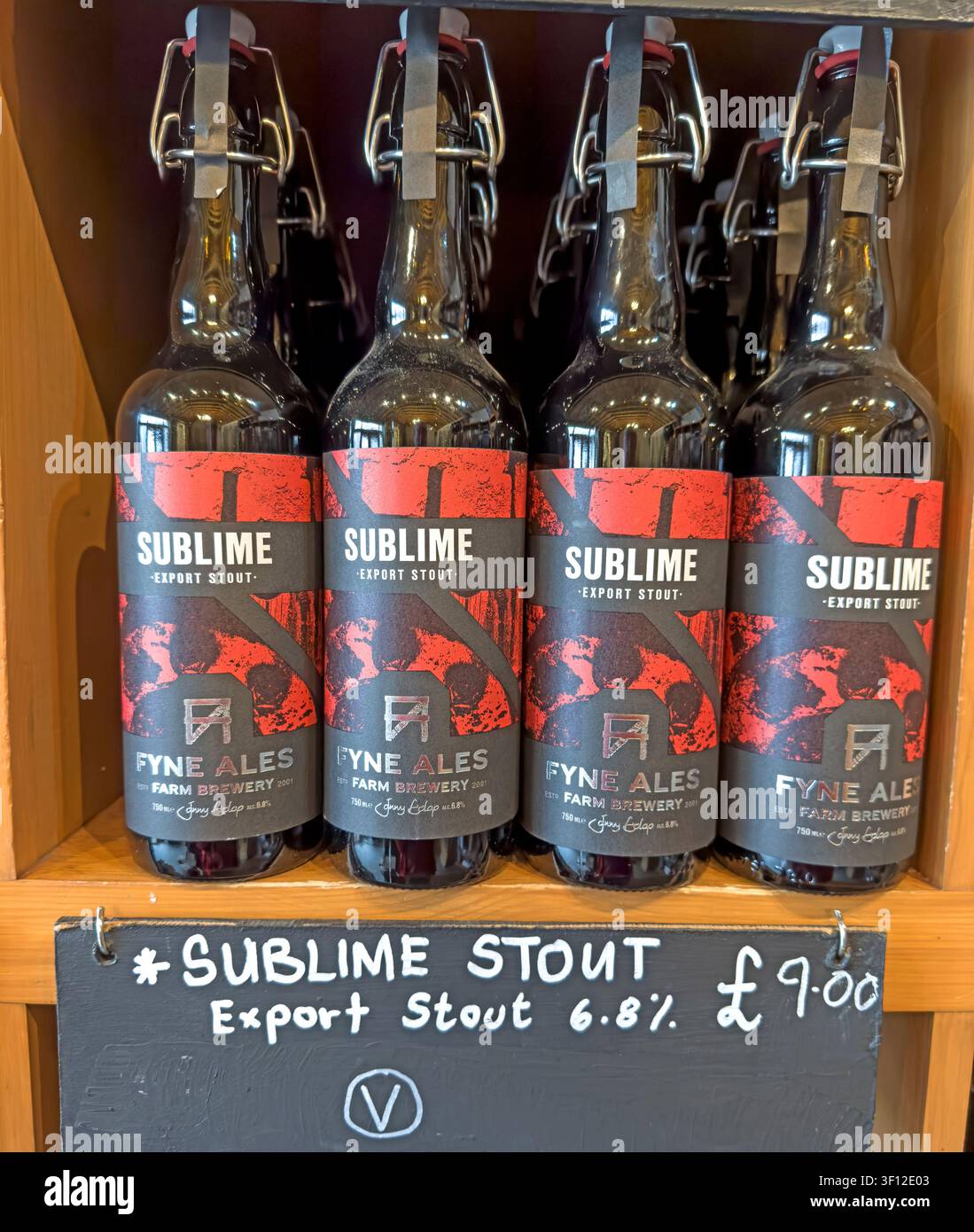 Fyne Ales Sublime Stout bottles on display with a handwritten price sign in a British pub or beer shop. Stock Photo