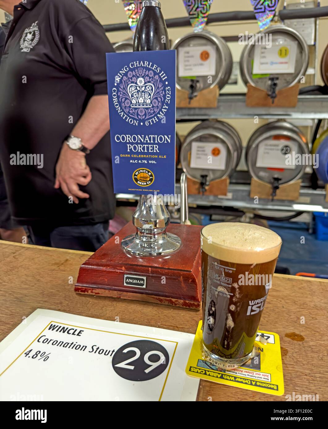 Wincle Coronation bitter or ale pump clip beside a pint of beer at Bellhouse lane, Grappenhall, Warrington, beer festival Stock Photo