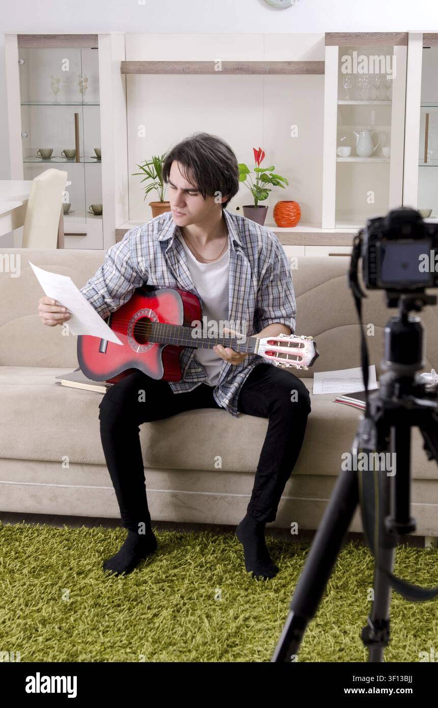 Young guitar player recording video for his blog Stock Photo