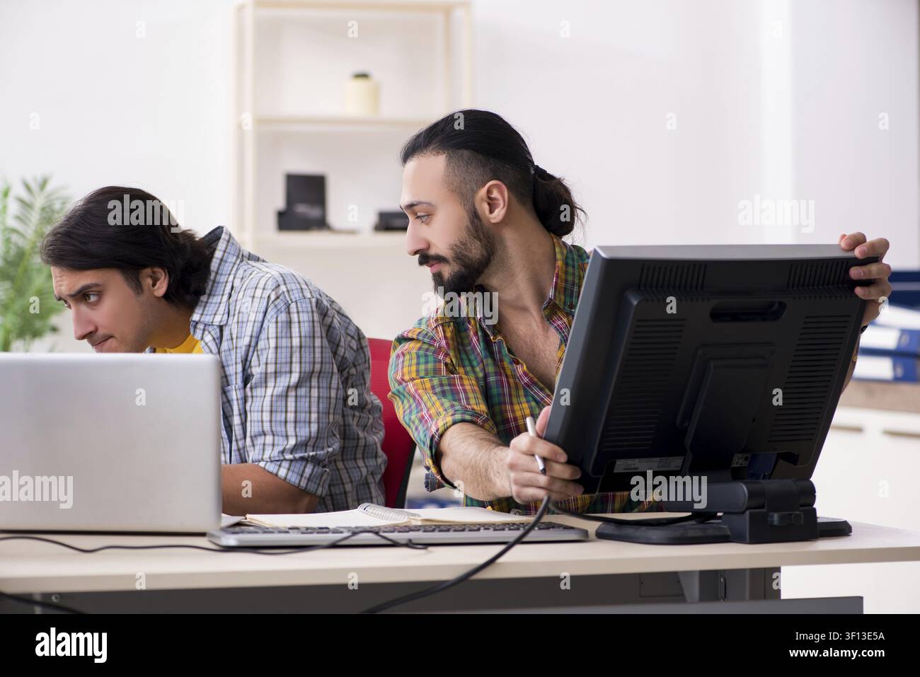Two it specialists working in the office Stock Photo