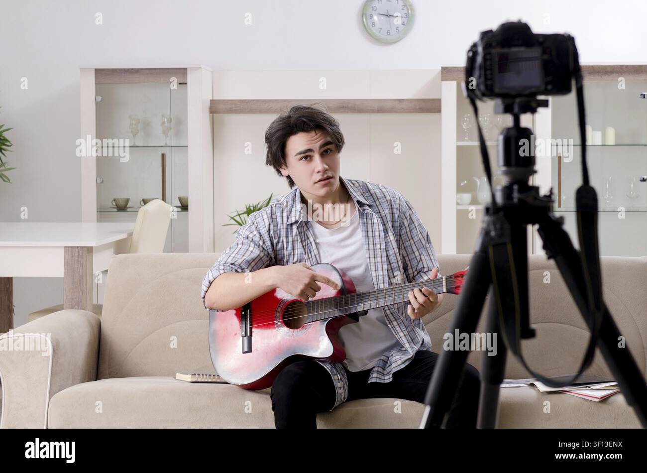 Young guitar player recording video for his blog Stock Photo