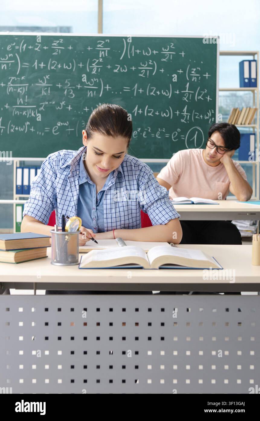 Young students taking the math exam in classroom Stock Photo