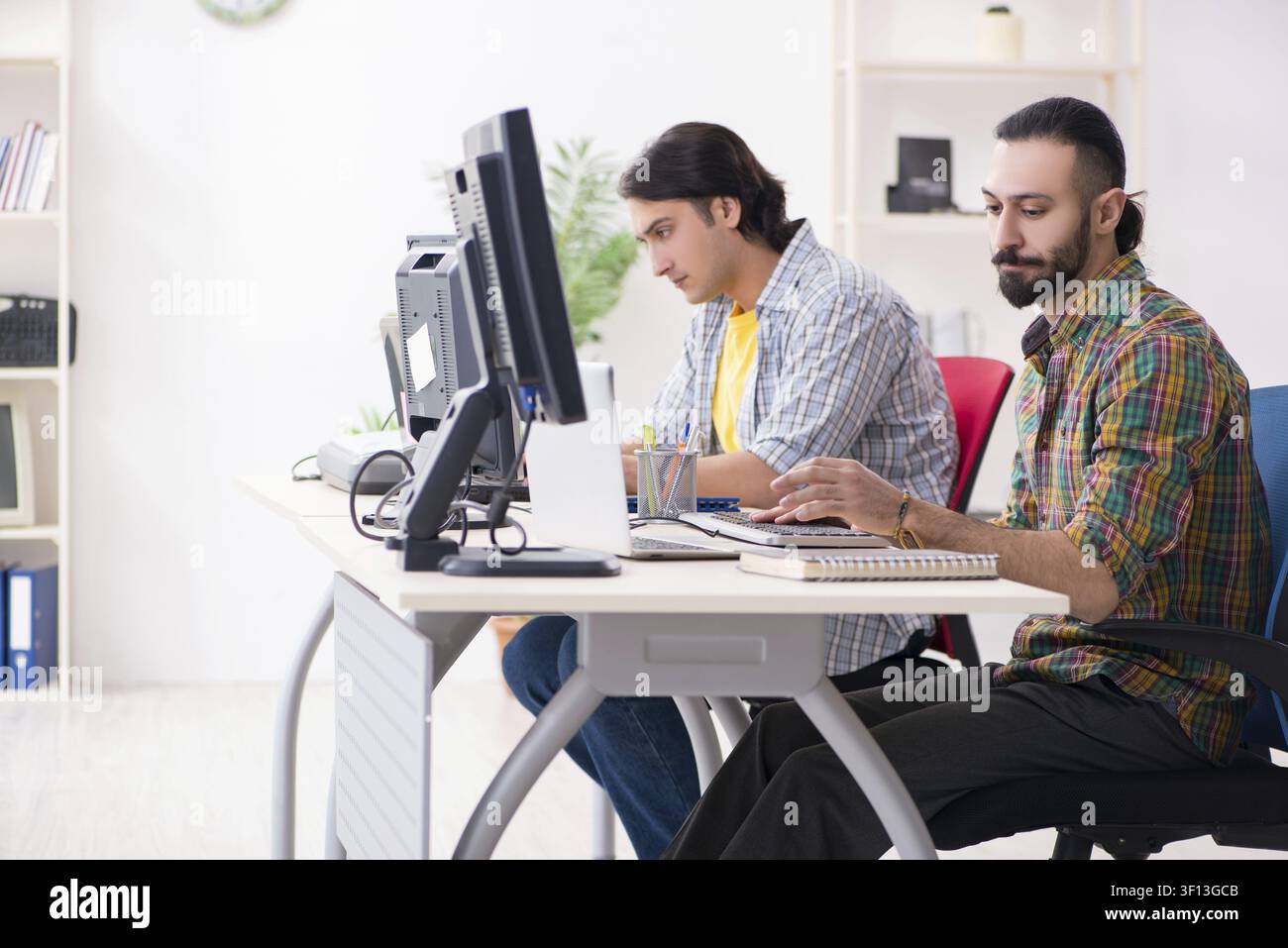 Two it specialists working in the office Stock Photo