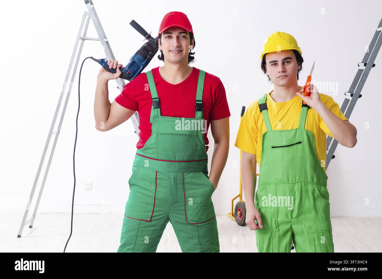 Two workers contractors working indoors Stock Photo