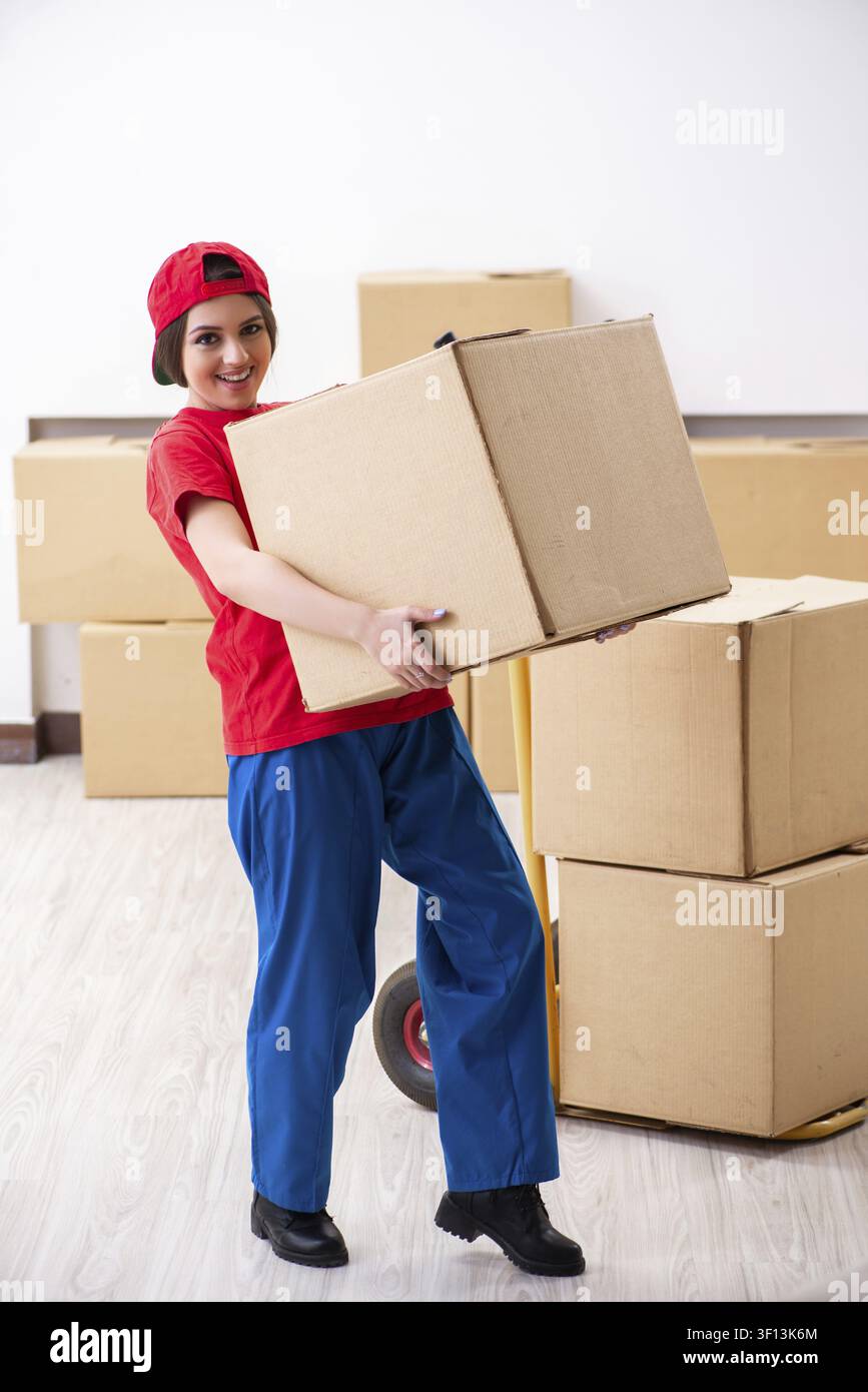 Young female professional mover doing home relocation Stock Photo