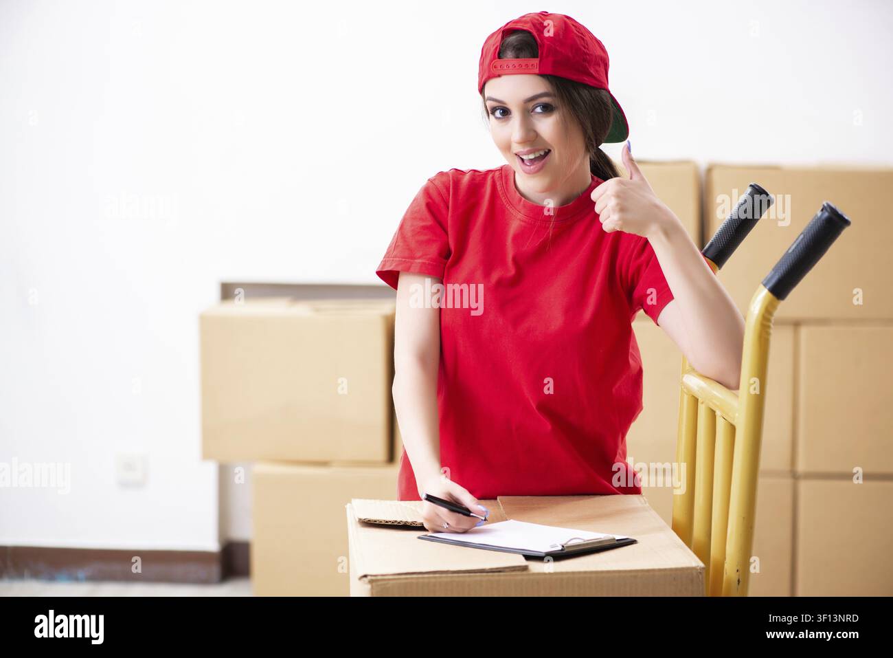 Young female professional mover doing home relocation Stock Photo