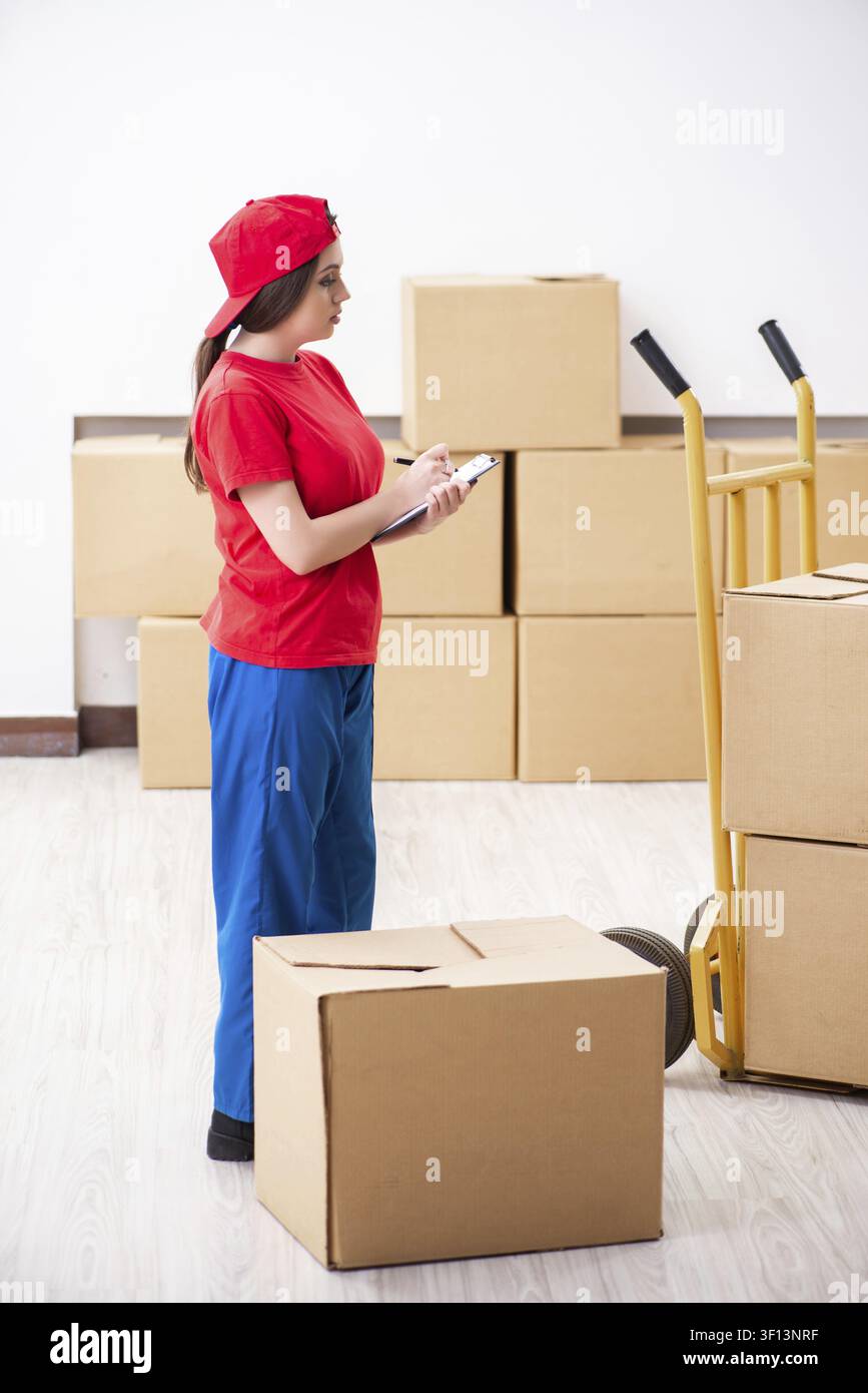 Young female professional mover doing home relocation Stock Photo
