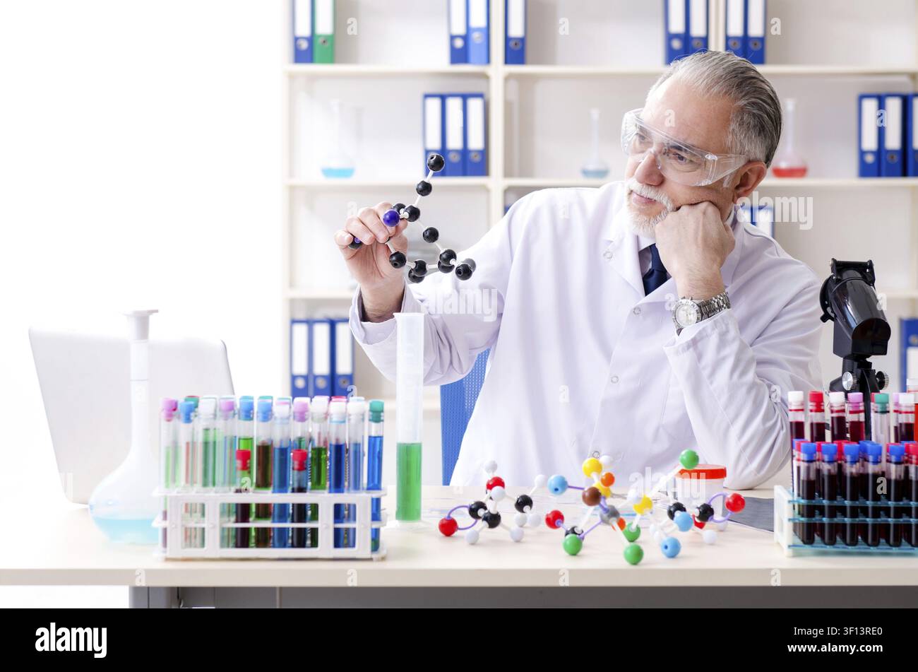Old male chemist working in the lab Stock Photo