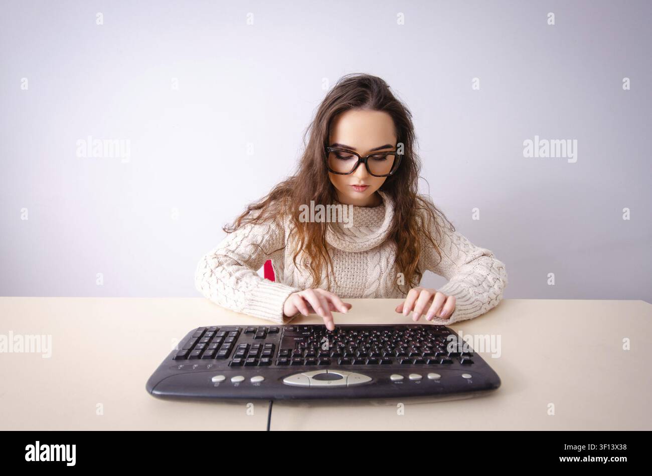 Funny nerd girl working on computer Stock Photo