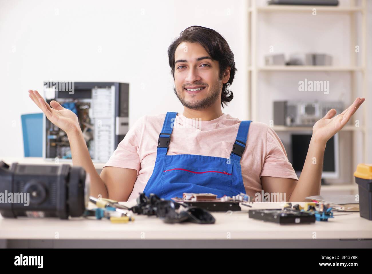 Young male contractor repairing computer Stock Photo