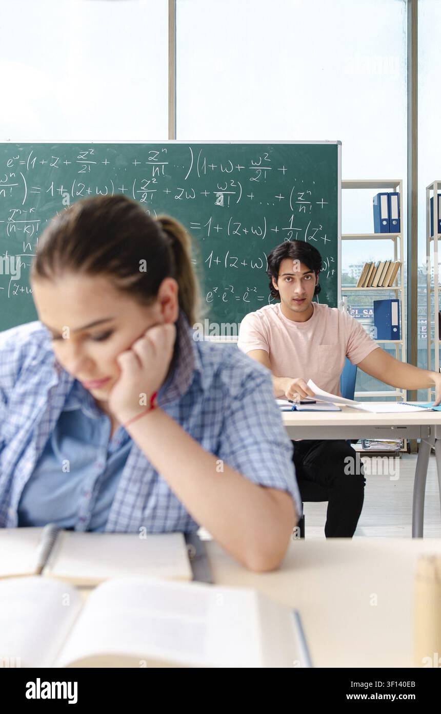 Young students taking the math exam in classroom Stock Photo