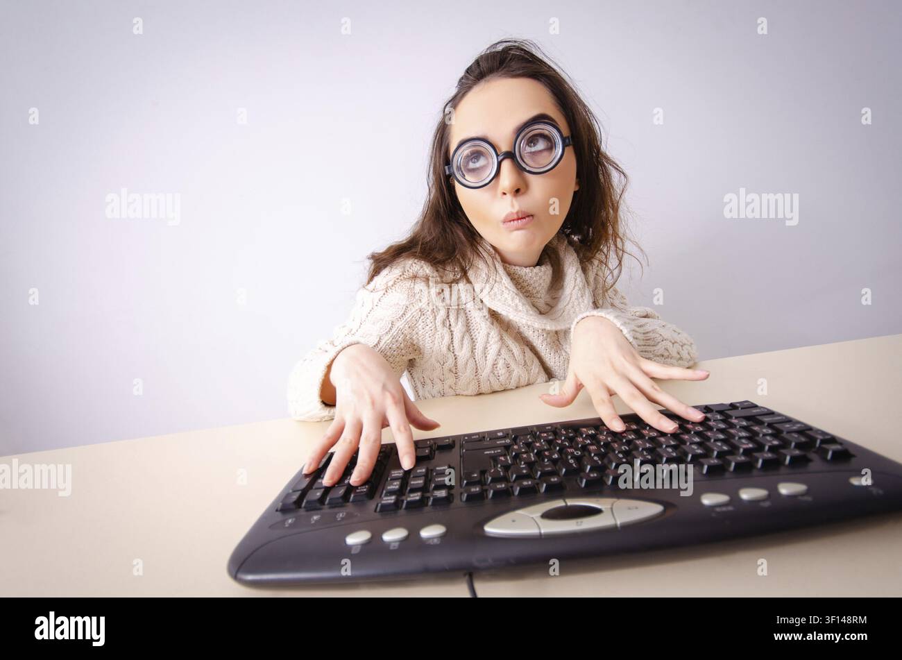 Funny nerd girl working on computer Stock Photo