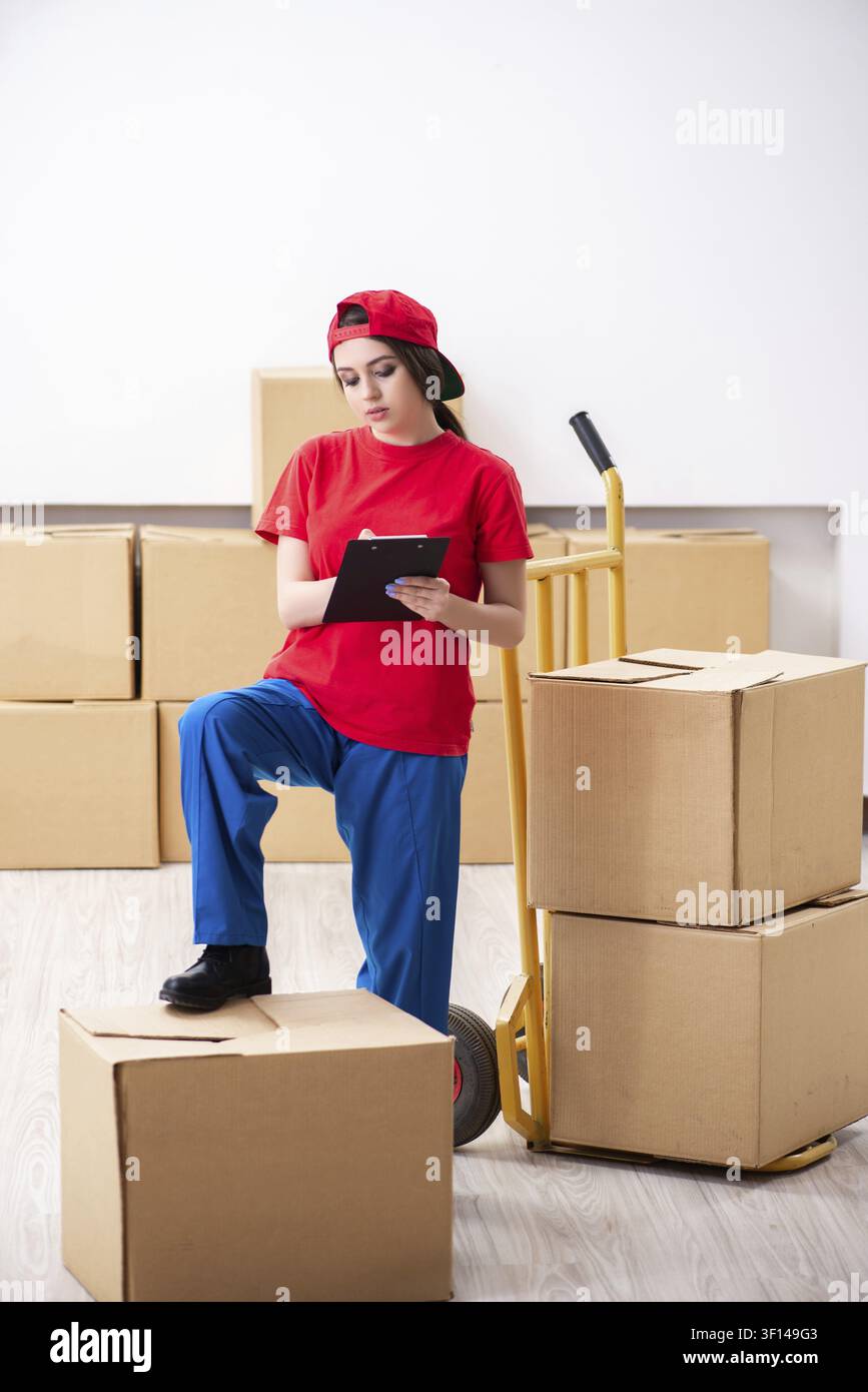 Young female professional mover doing home relocation Stock Photo