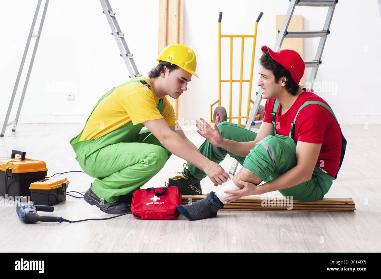 Injured worker and his workmate Stock Photo