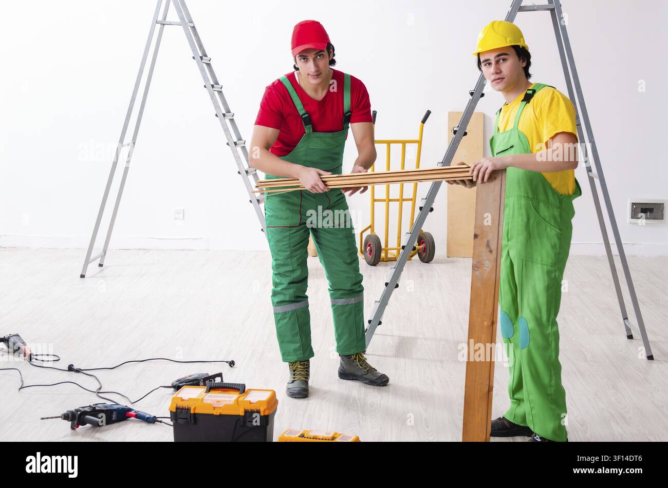 Two workers contractors working indoors Stock Photo