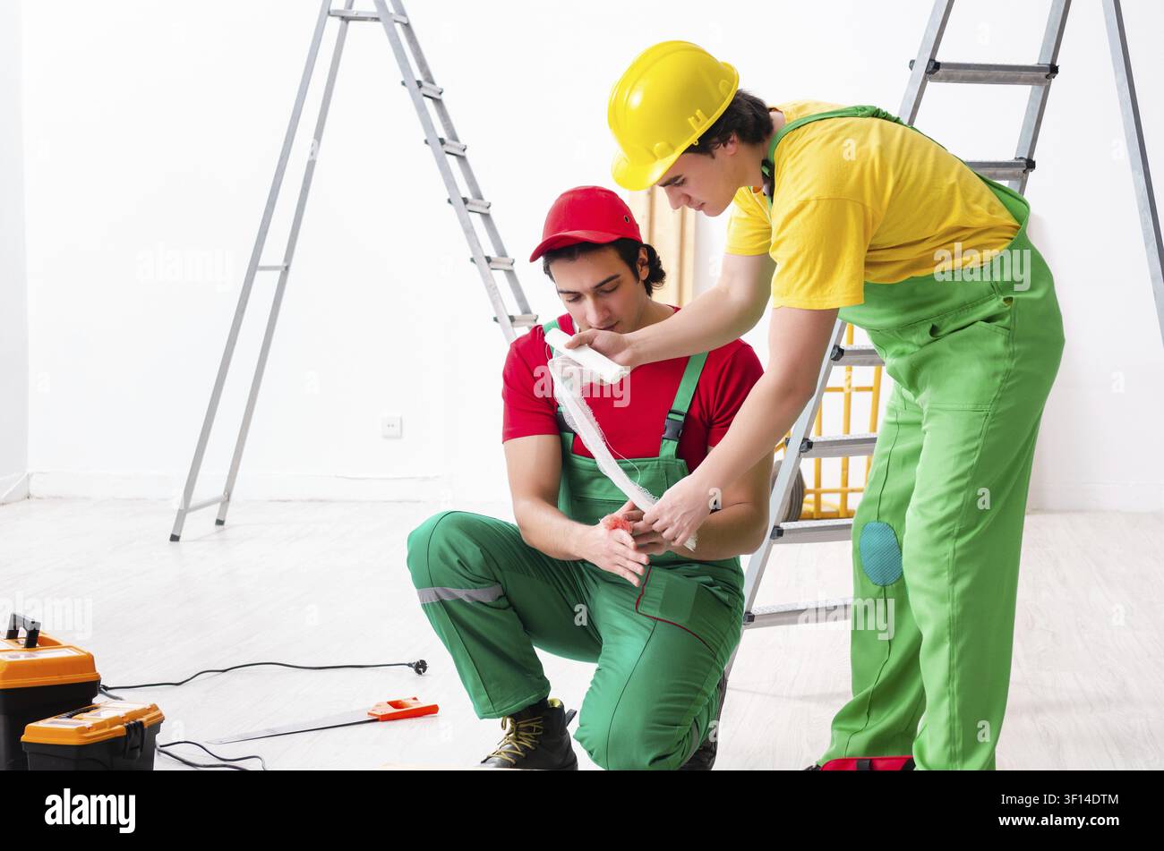 Injured worker and his workmate Stock Photo