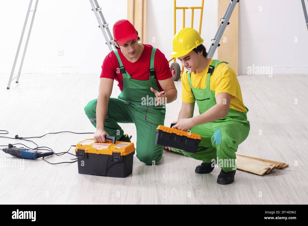 Two workers contractors working indoors Stock Photo