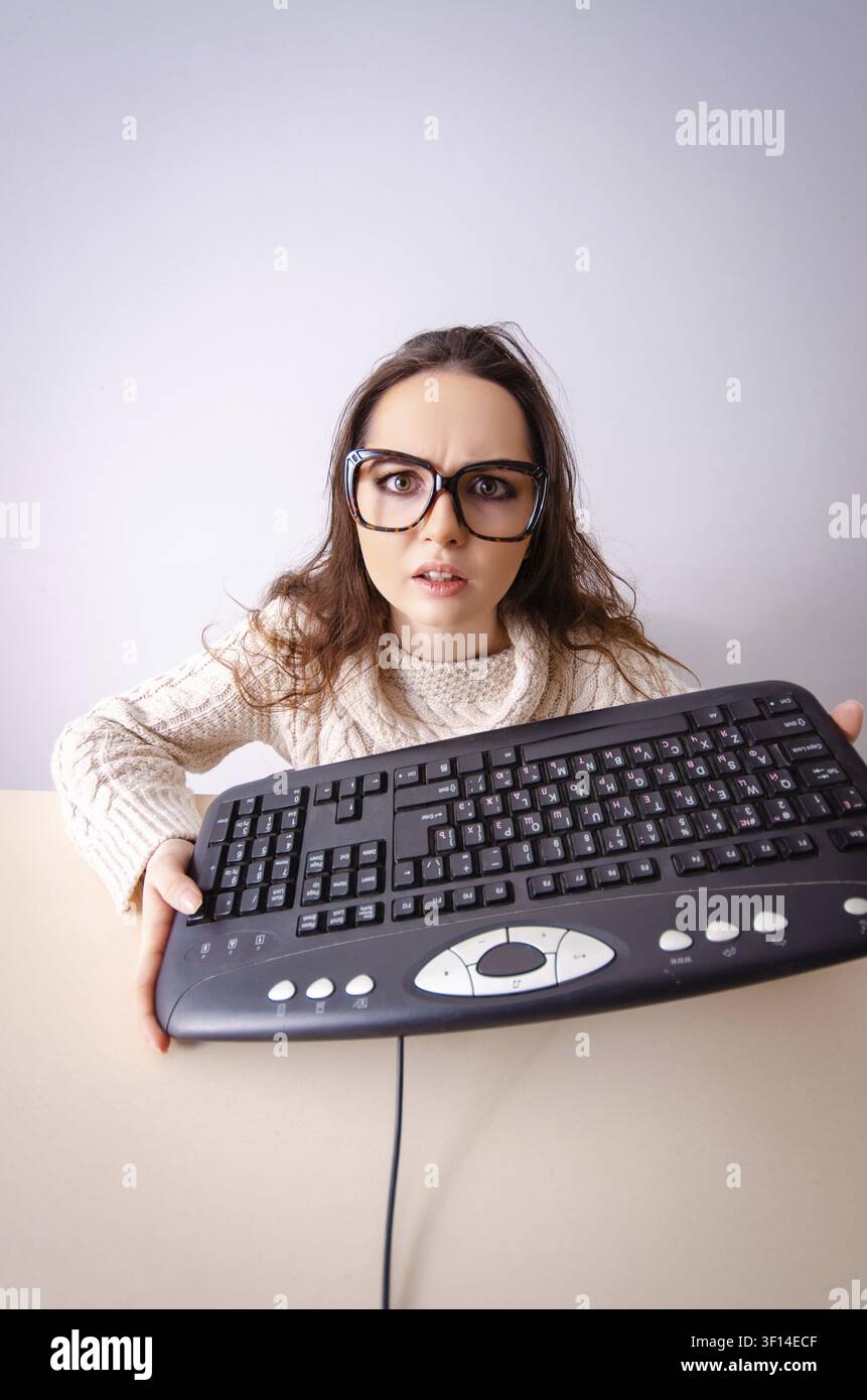 Funny nerd girl working on computer Stock Photo