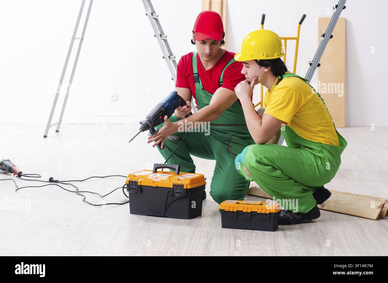 Two workers contractors working indoors Stock Photo