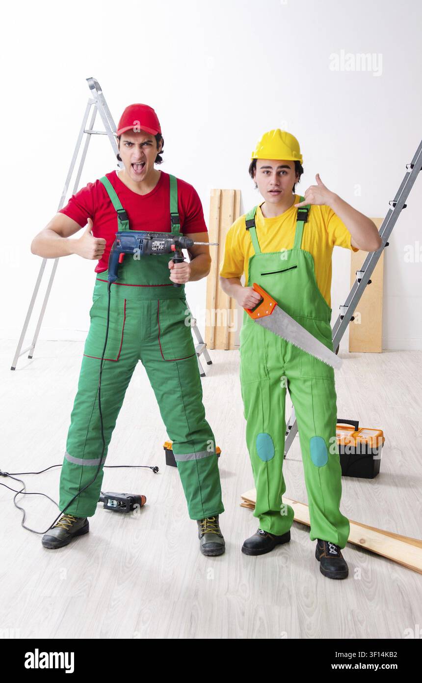 Two workers contractors working indoors Stock Photo