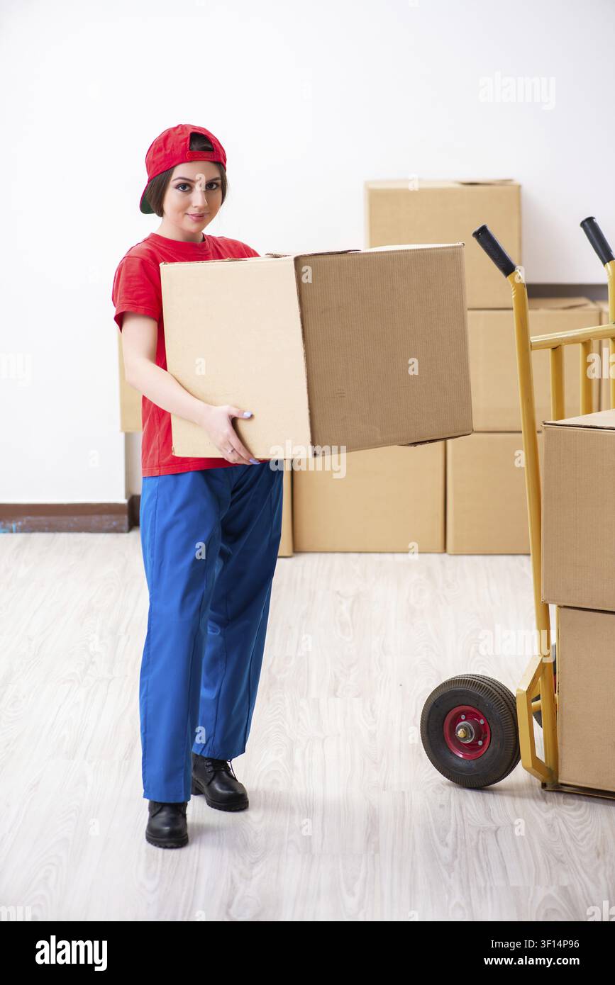 Young female professional mover doing home relocation Stock Photo