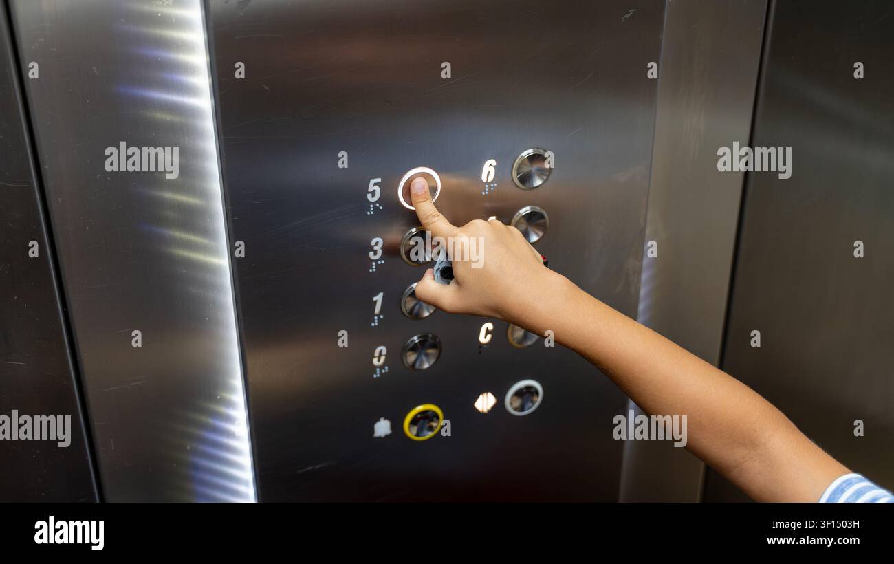 Child Pressing Elevator Button Inside Modern Lift Close Up Stock Photo