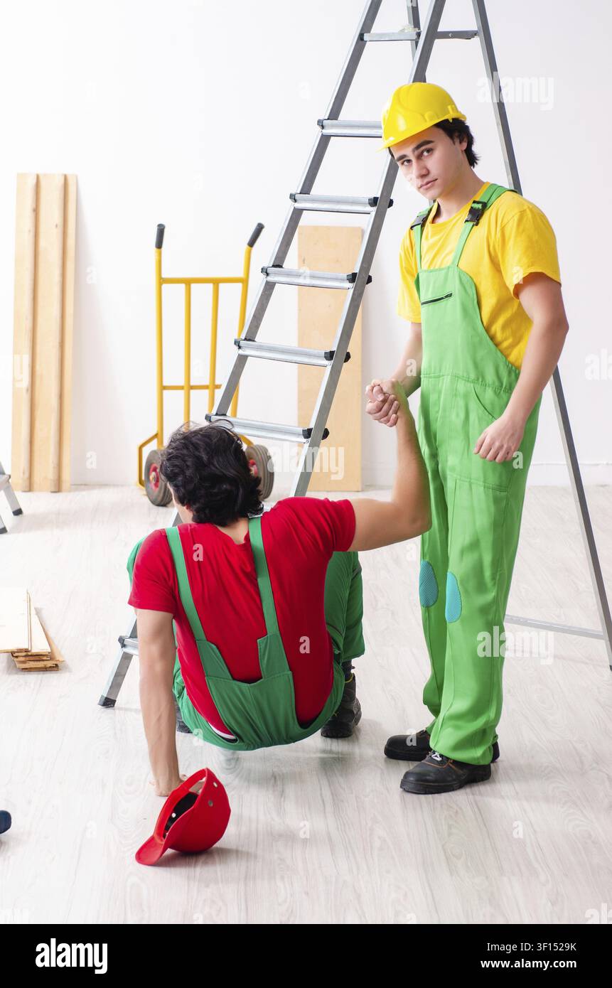 Injured worker and his workmate Stock Photo