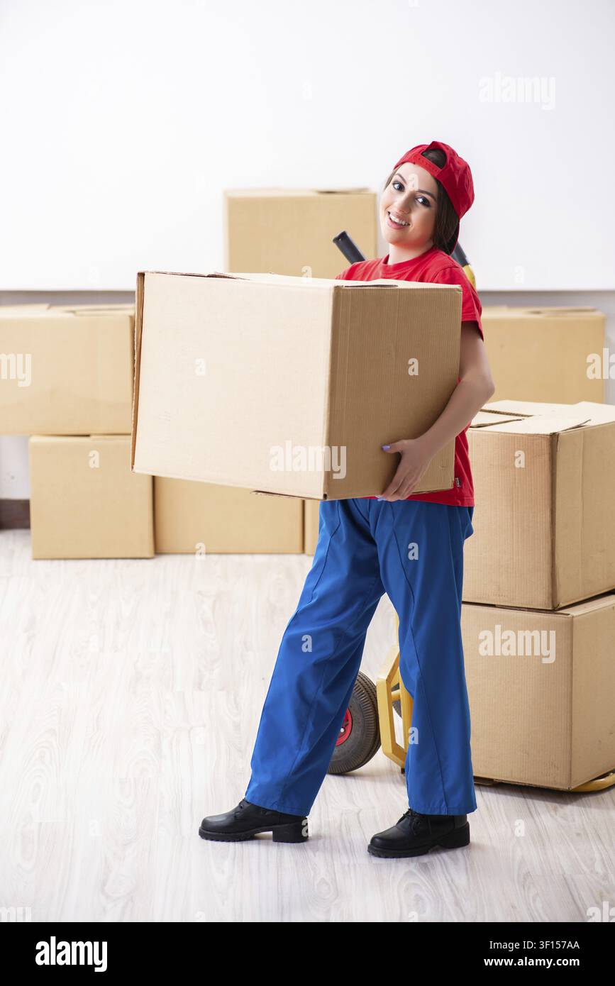 Young female professional mover doing home relocation Stock Photo