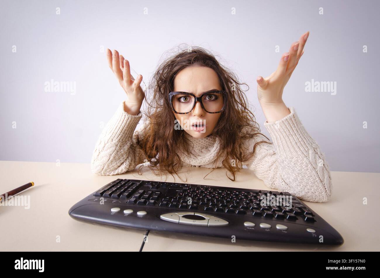 Funny nerd girl working on computer Stock Photo