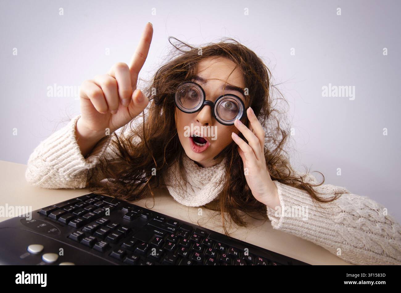 Funny nerd girl working on computer Stock Photo