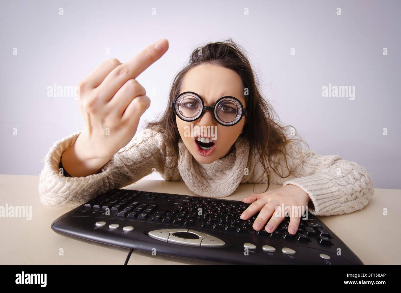 Funny nerd girl working on computer Stock Photo