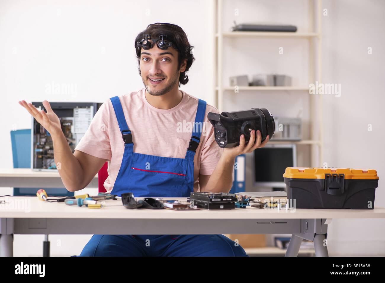 Young male contractor repairing computer Stock Photo