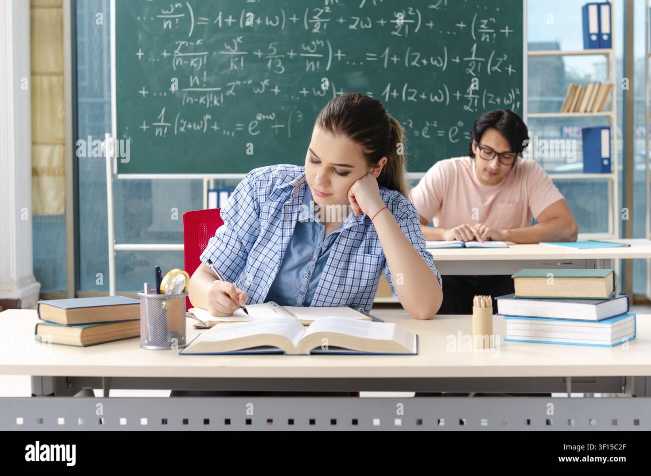Young students taking the math exam in classroom Stock Photo