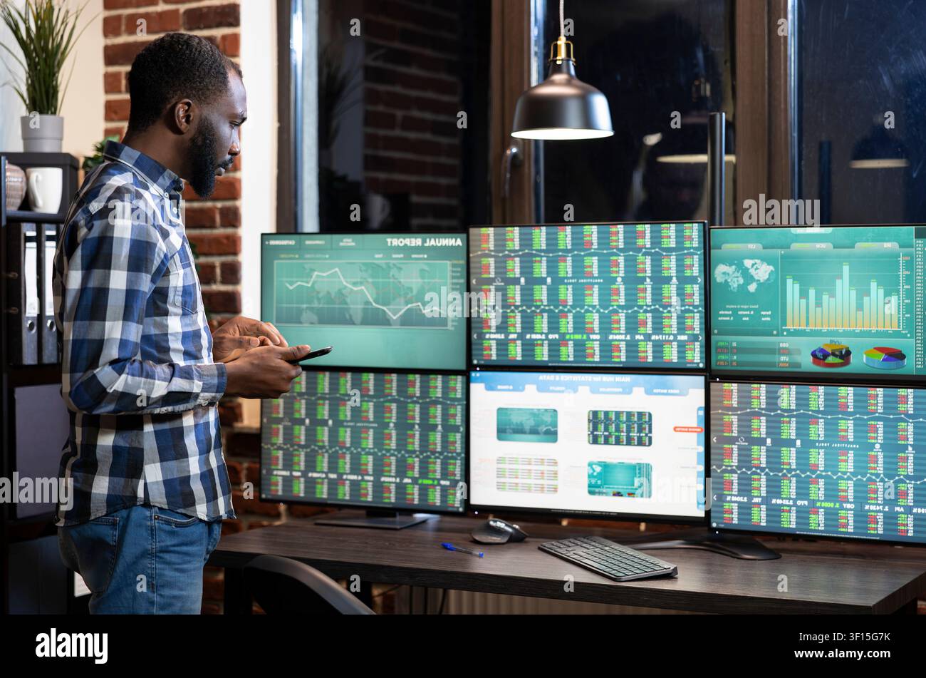 Financial analyst reviewing forex market trends Financial analyst using tablet and reviewing forex market trends on multi screen setup in a modern office. Stock Photo