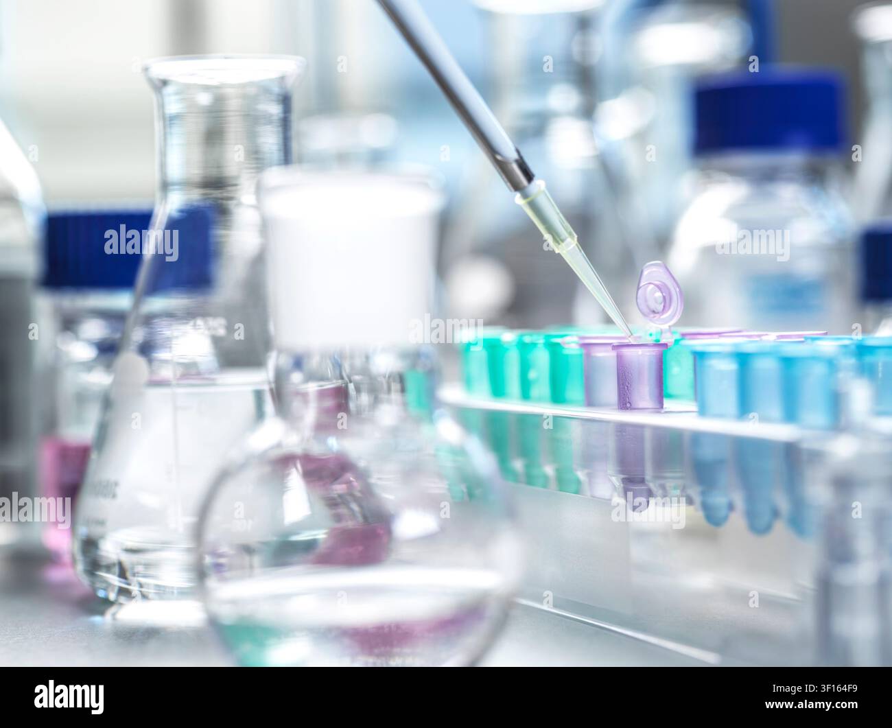Genetic research, conceptual image. Scientist extracting samples using a pipette for analytical testing in the lab. Stock Photo