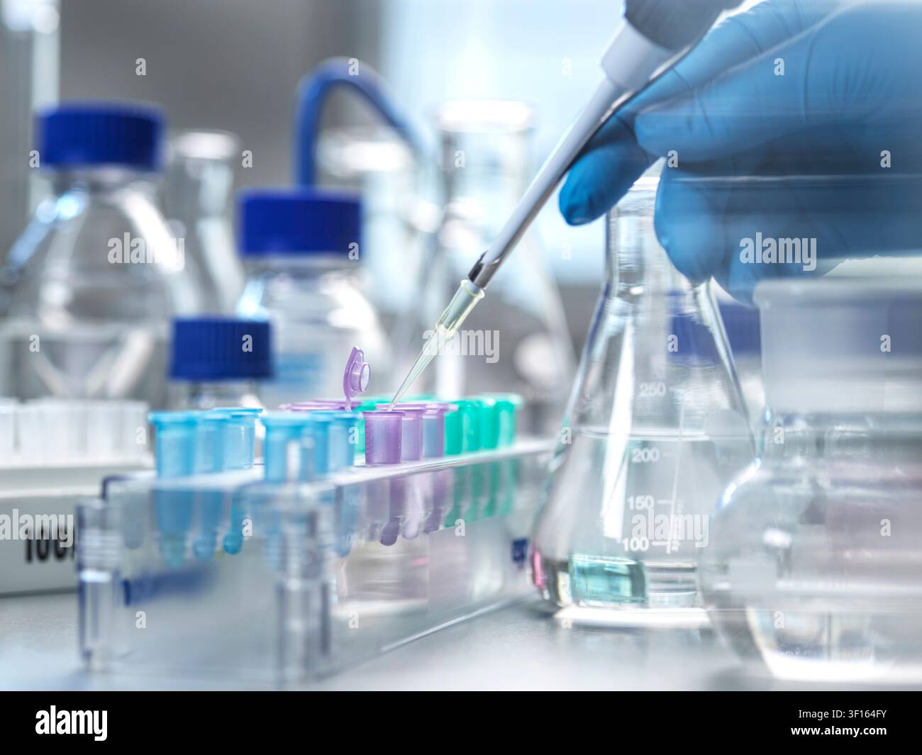 Genetic research, conceptual image. Scientist extracting samples using a pipette for analytical testing in the lab. Stock Photo